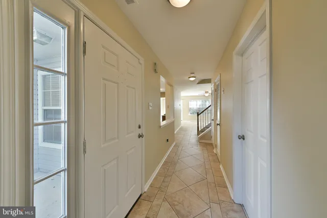 a bathroom with a double vanity sink and glass door