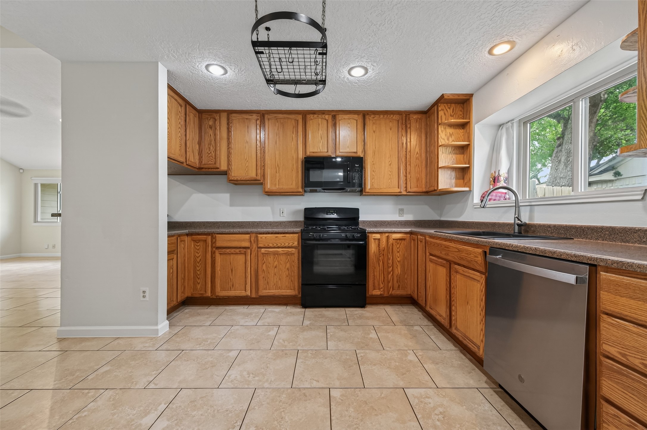 21315 Meadowhill Drive Spring, TX 77388 - Photo 11 of 31 a kitchen with a sink window and cabinets