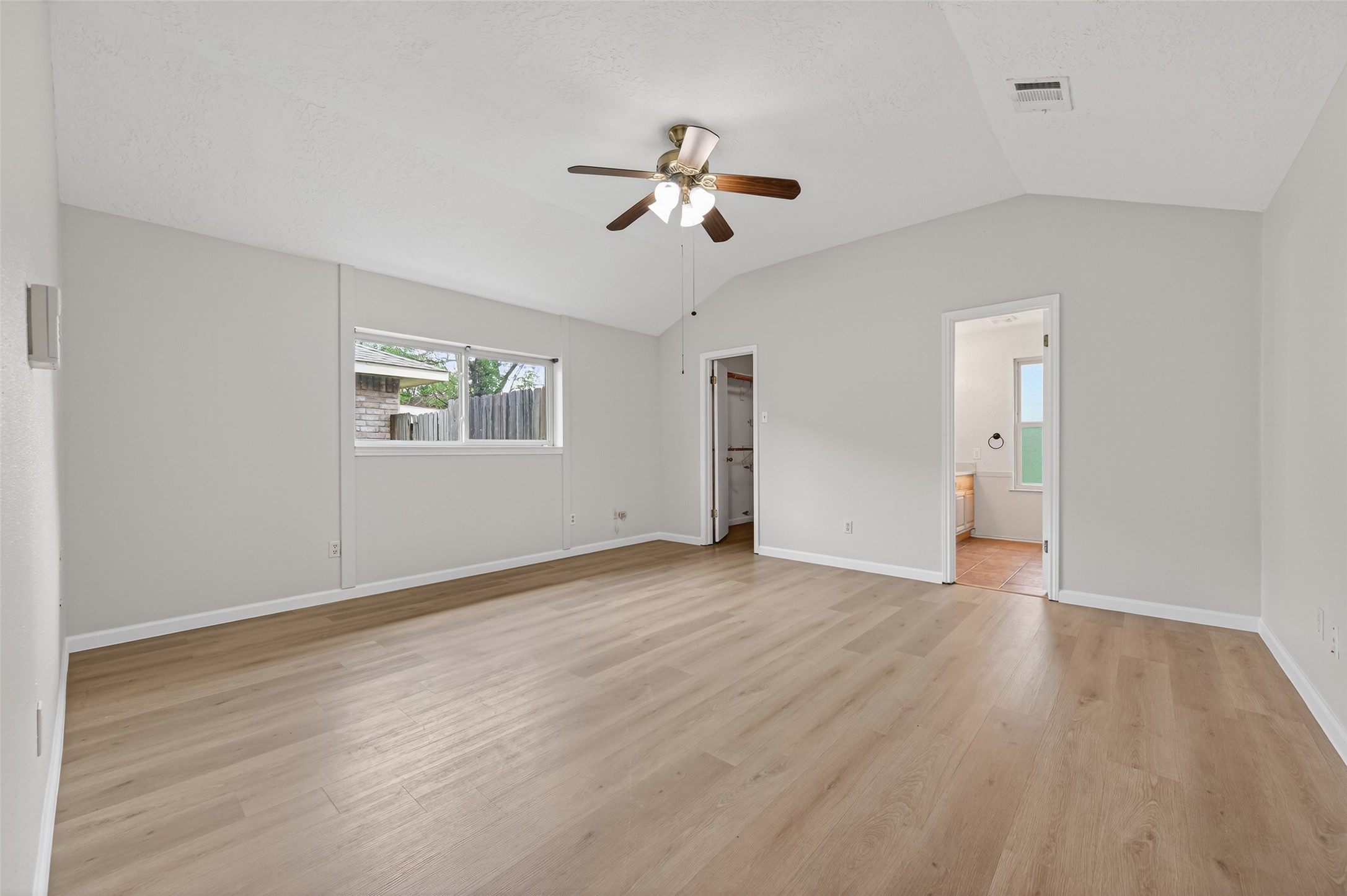 21315 Meadowhill Drive Spring, TX 77388 - Photo 14 of 31 an empty room with wooden floor ceiling fan and windows