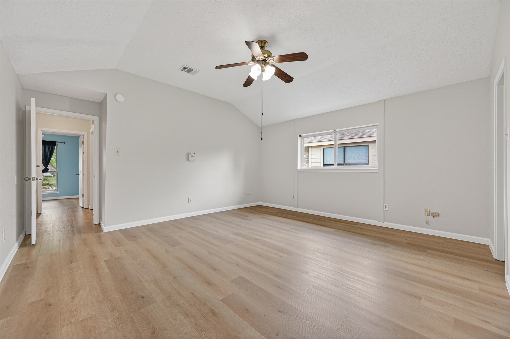 21315 Meadowhill Drive Spring, TX 77388 - Photo 15 of 31 a view of an empty room with wooden floor and a ceiling fan