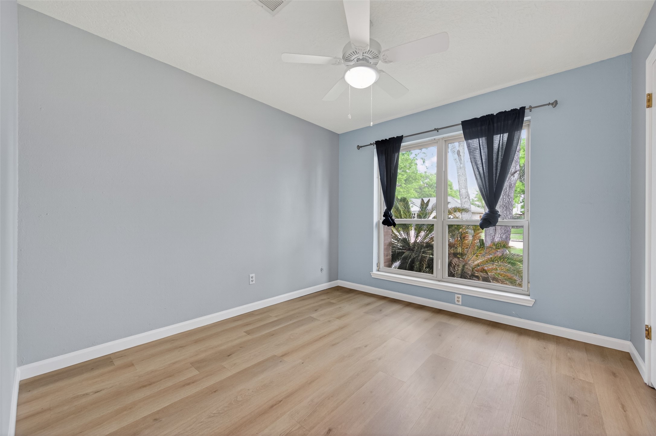21315 Meadowhill Drive Spring, TX 77388 - Photo 22 of 31 an empty room with wooden floor fan and windows