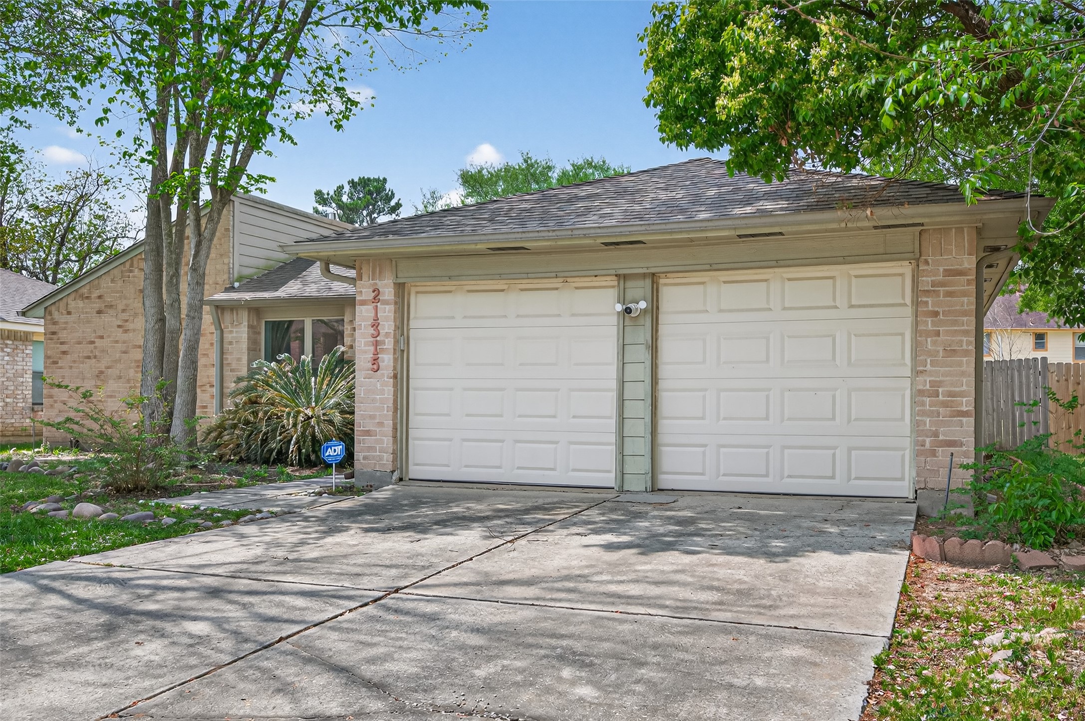 21315 Meadowhill Drive Spring, TX 77388 - Photo 31 of 31 a front view of a house with a yard and garage