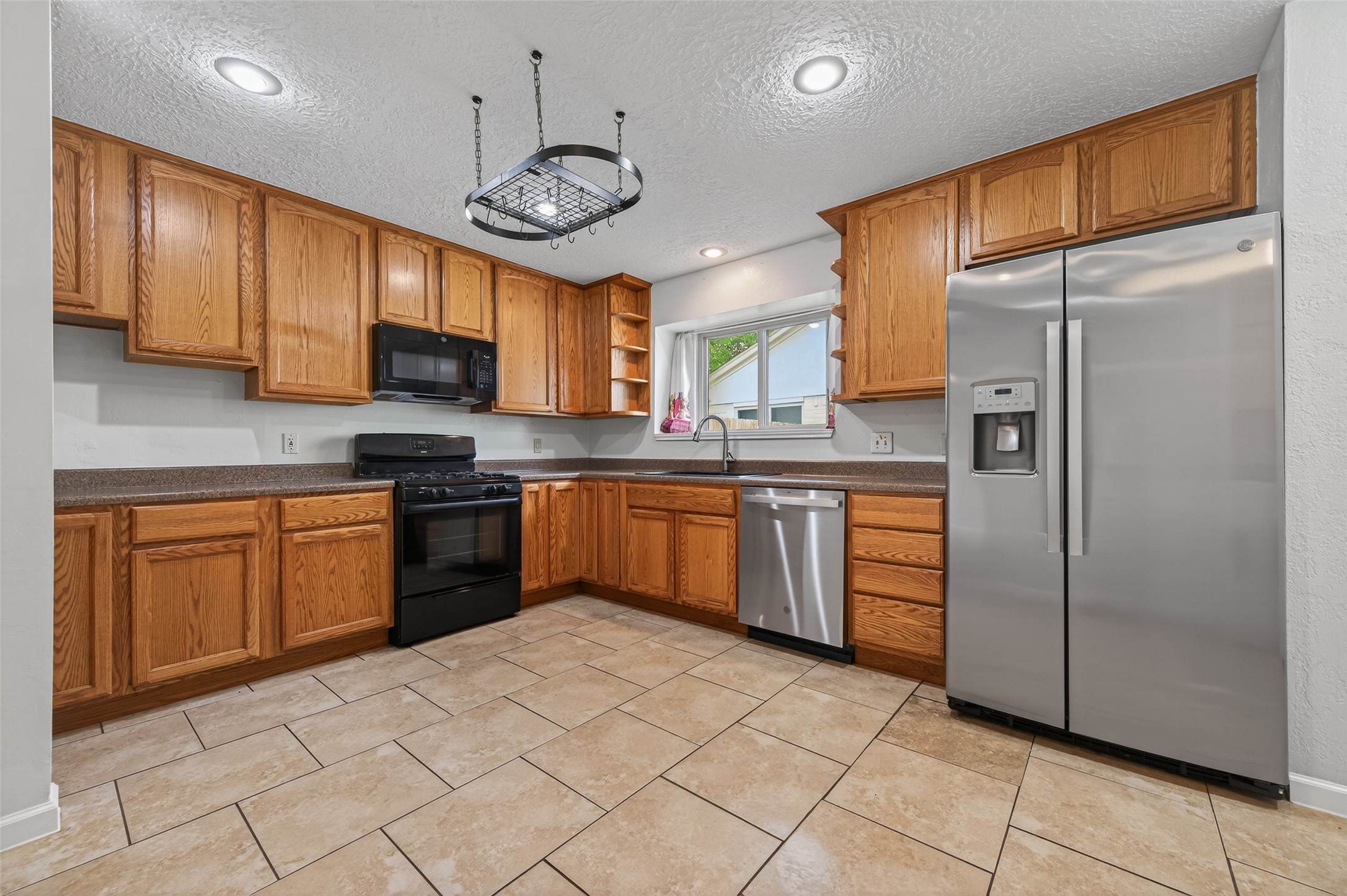 21315 Meadowhill Drive Spring, TX 77388 - Photo 10 of 31 a kitchen with stainless steel appliances granite countertop a refrigerator a sink dishwasher a stove and a refrigerator