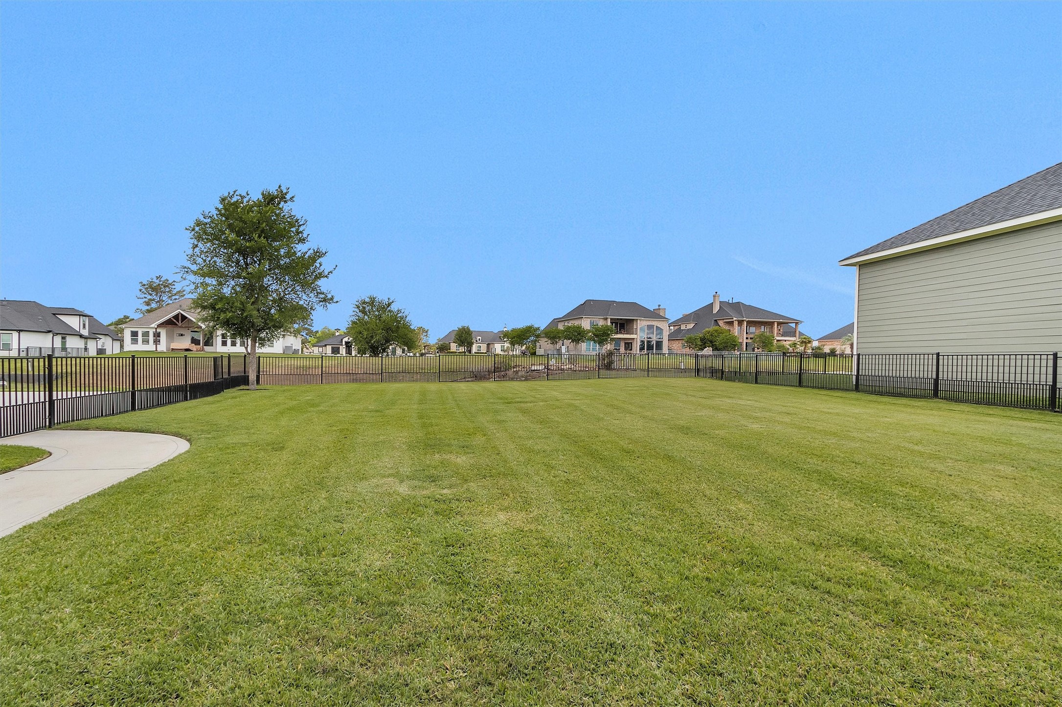 10887 Decatur Street Willis, TX 77318 - Photo 46 of 50 The space stretches out level and clean, backing to a quiet canal with no rear neighbors crowding in. That water backdrop brings a calm, hard-to-find setting with plenty of room to add a pool or simply enjoy the space exactly as it sits.