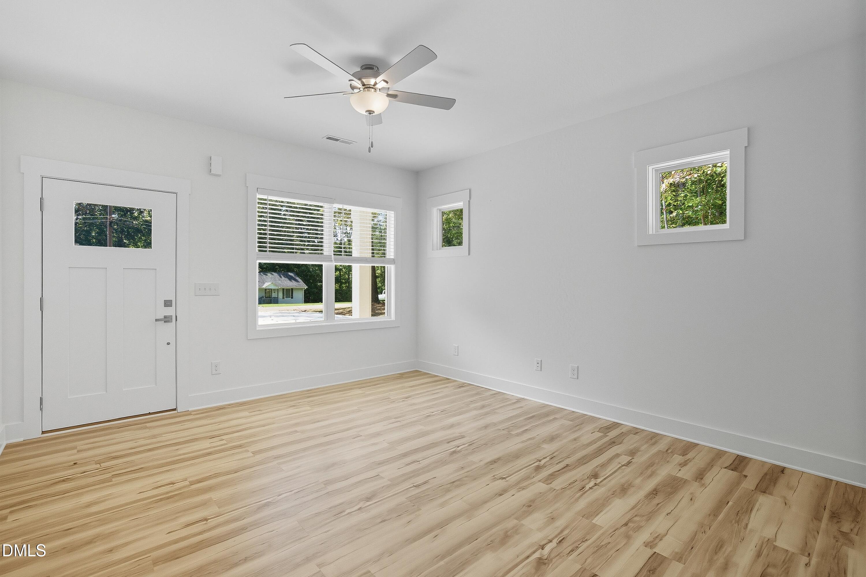 97 Gates Street Roxboro, NC 27573 - Photo 13 of 34 a view of an empty room with wooden floor and window