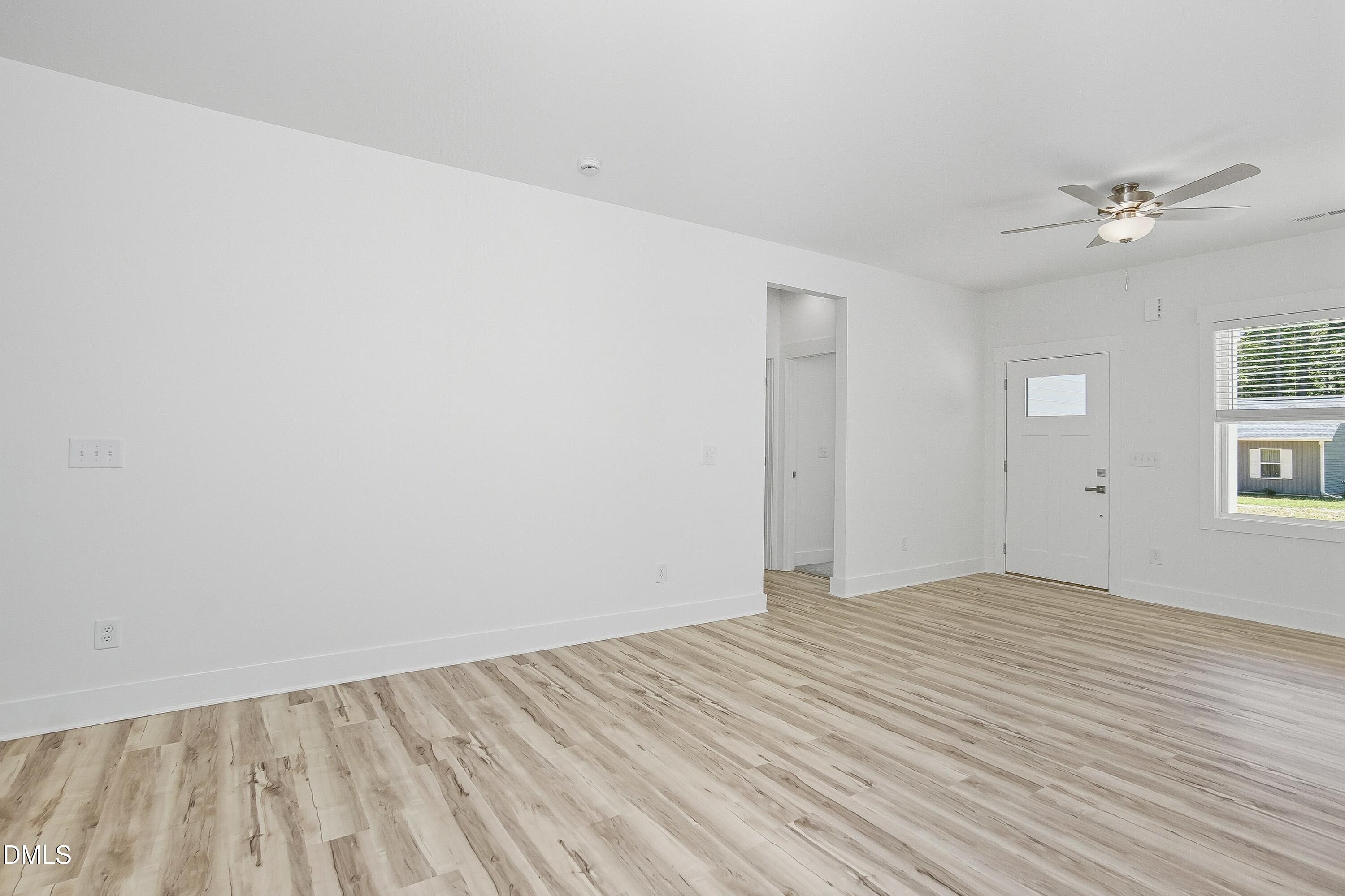 97 Gates Street Roxboro, NC 27573 - Photo 16 of 34 a view of empty room with wooden floor and fan