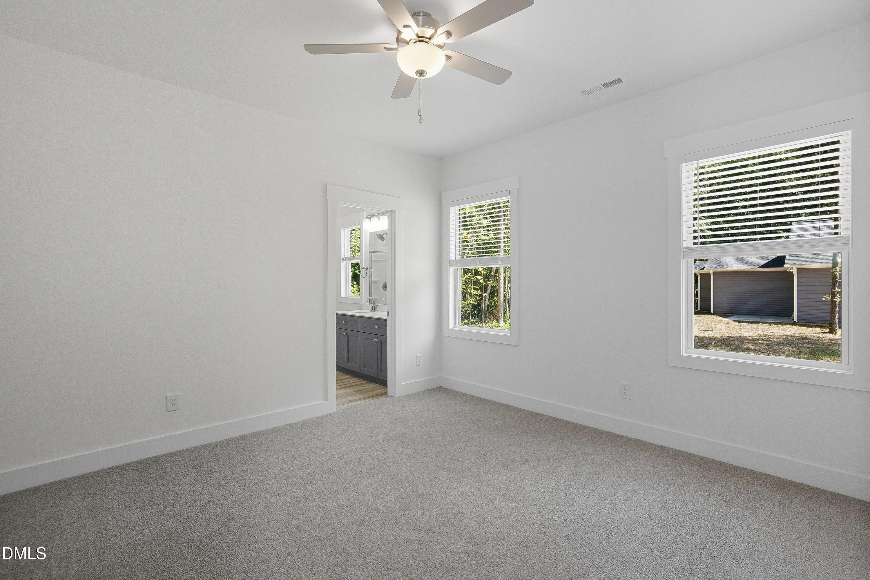 97 Gates Street Roxboro, NC 27573 - Photo 17 of 34 an empty room with windows and fan