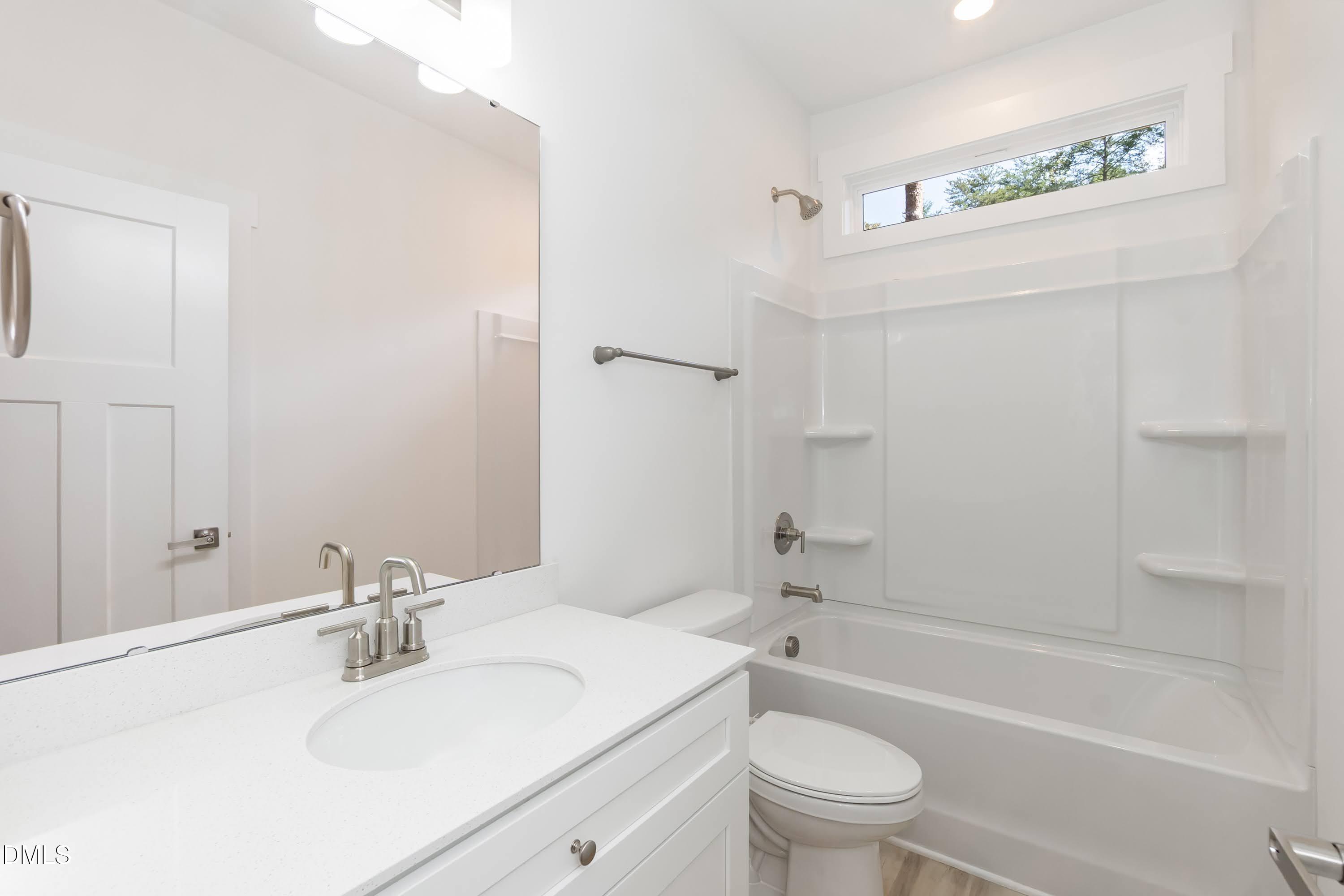 97 Gates Street Roxboro, NC 27573 - Photo 25 of 34 a bathroom with a sink a toilet and a bathtub