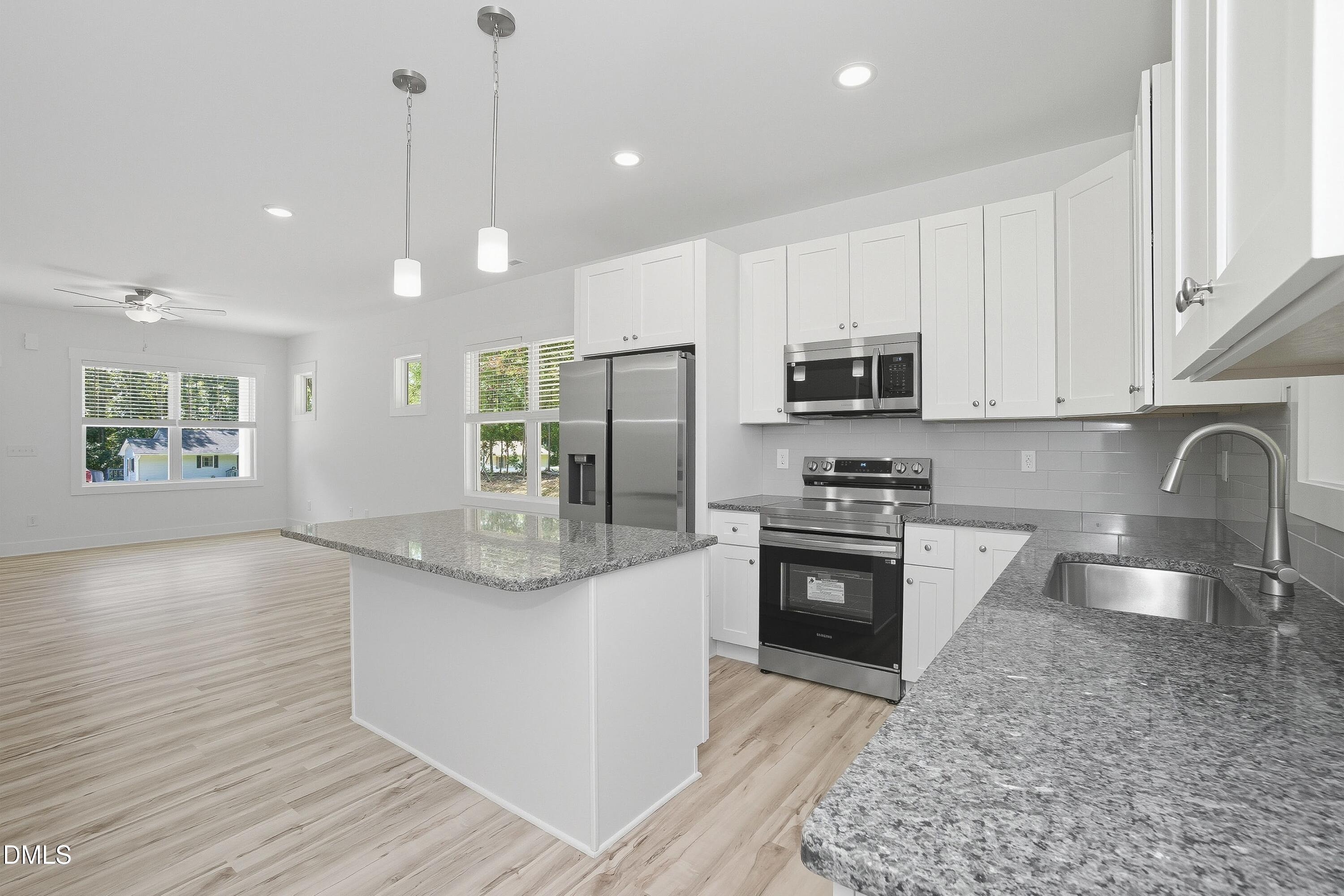 97 Gates Street Roxboro, NC 27573 - Photo 8 of 34 a kitchen with stainless steel appliances granite countertop a stove a sink and a refrigerator