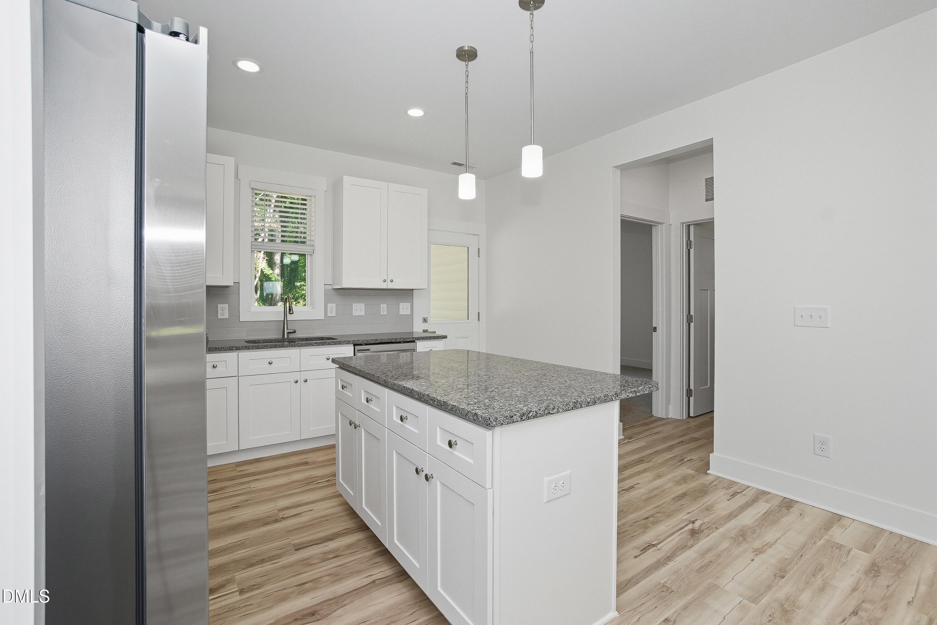97 Gates Street Roxboro, NC 27573 - Photo 10 of 34 a kitchen with granite countertop a sink a counter space appliances and cabinets