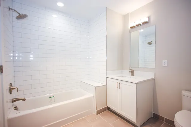 a bathroom with a bathtub a sink a toilet a and a shower