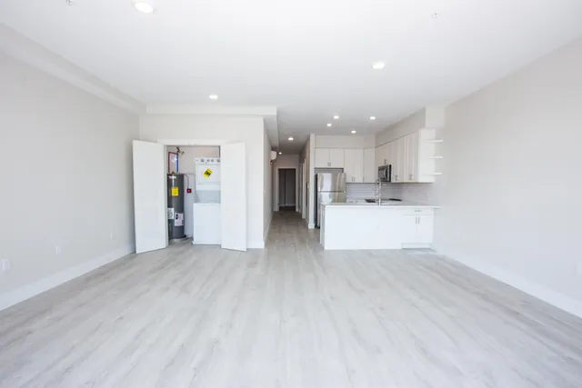 a view of a kitchen with a sink and a refrigerator