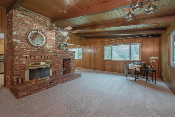 a view of a livingroom with fireplace and furniture