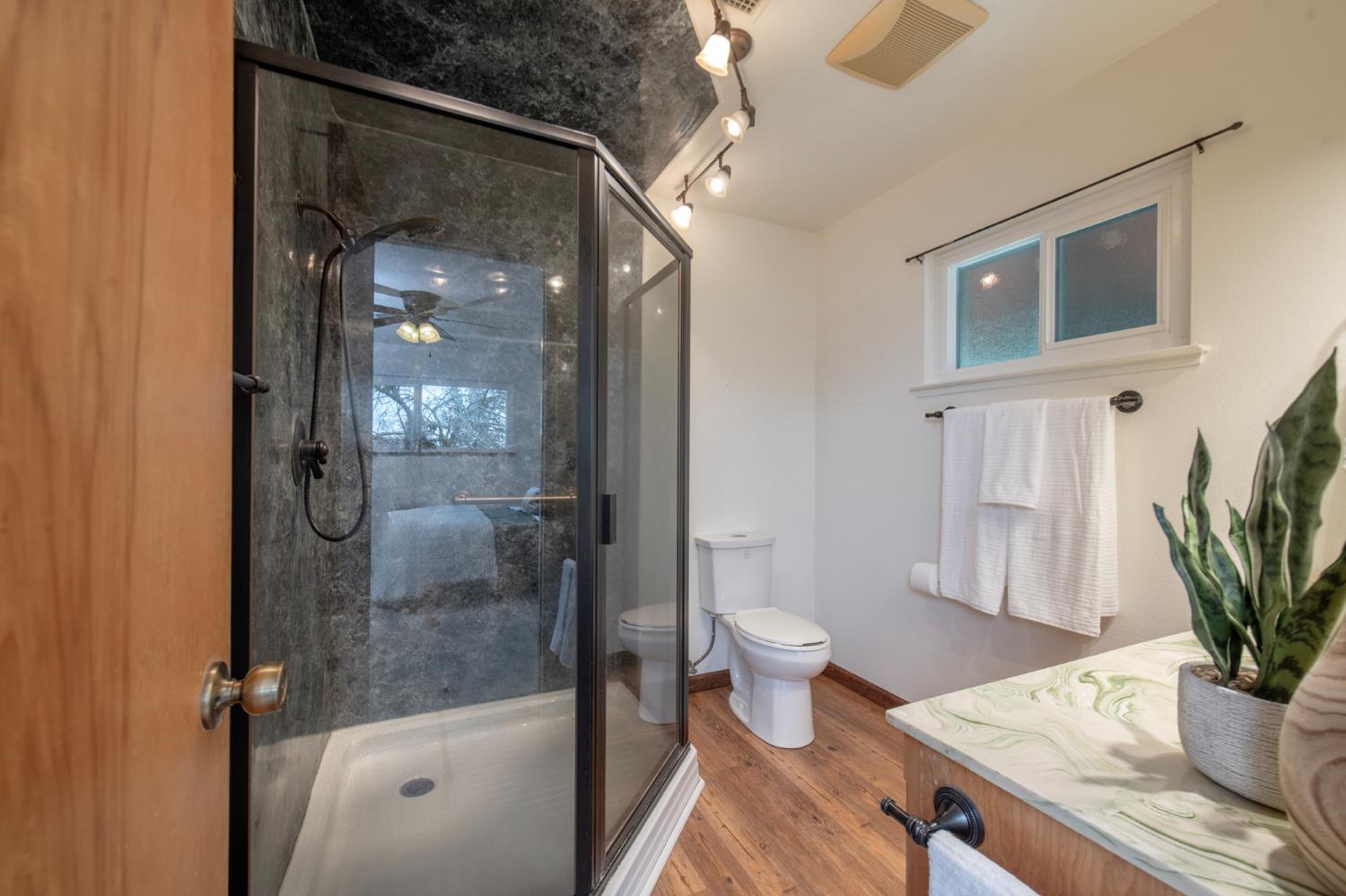 21256 Tollhouse Road Clovis, CA 93619 - Photo 18 of 30 a bathroom with a sink toilet and shower