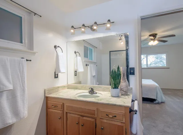 a bathroom with a double vanity sink and a mirror
