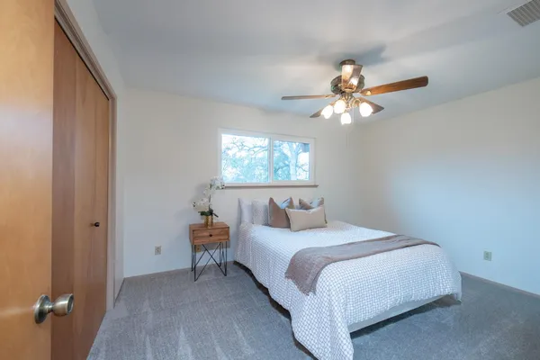 a bedroom with a bed and a chandelier