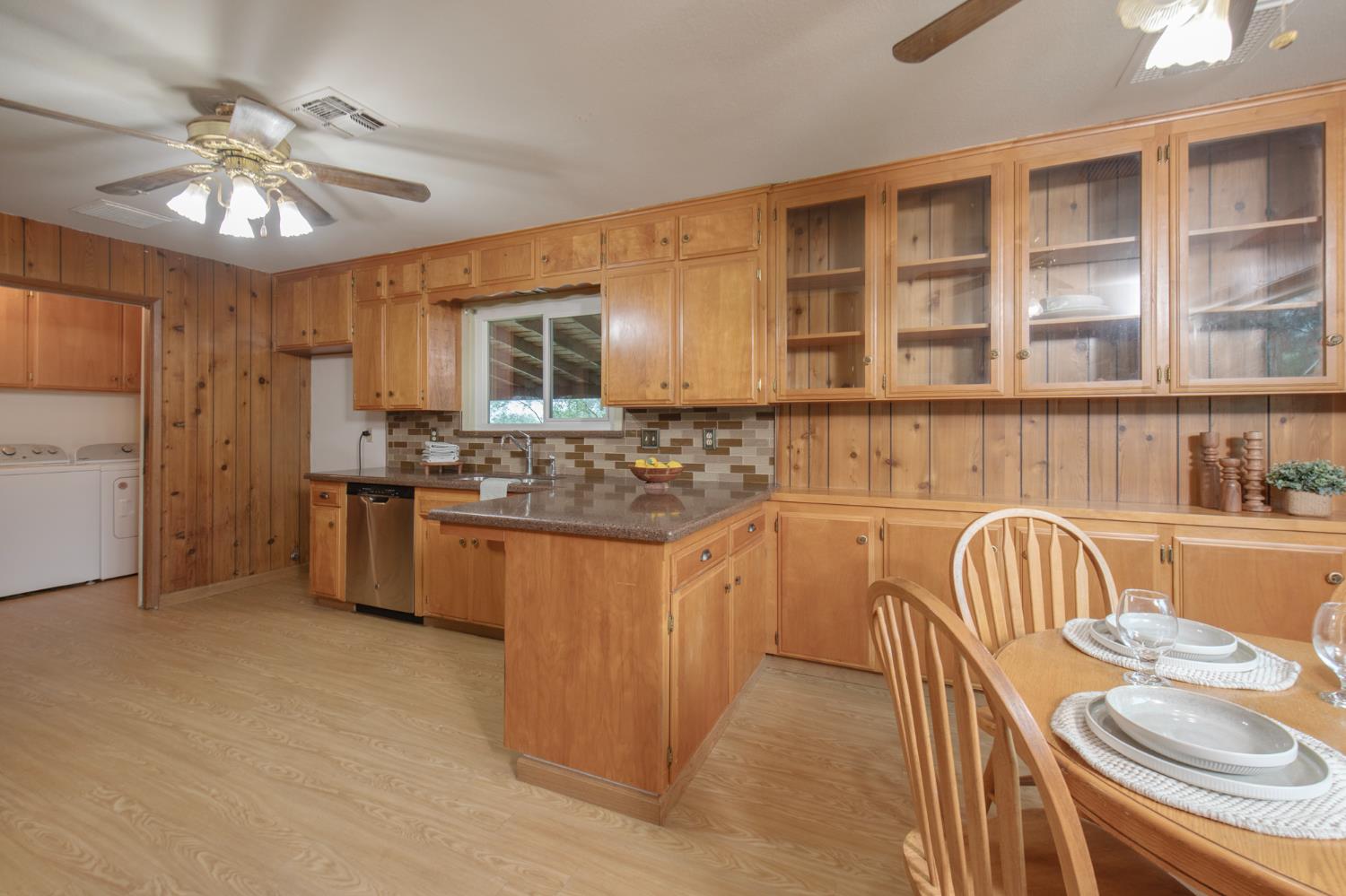 21256 Tollhouse Road Clovis, CA 93619 - Photo 7 of 30 a kitchen with stainless steel appliances granite countertop a sink and stove