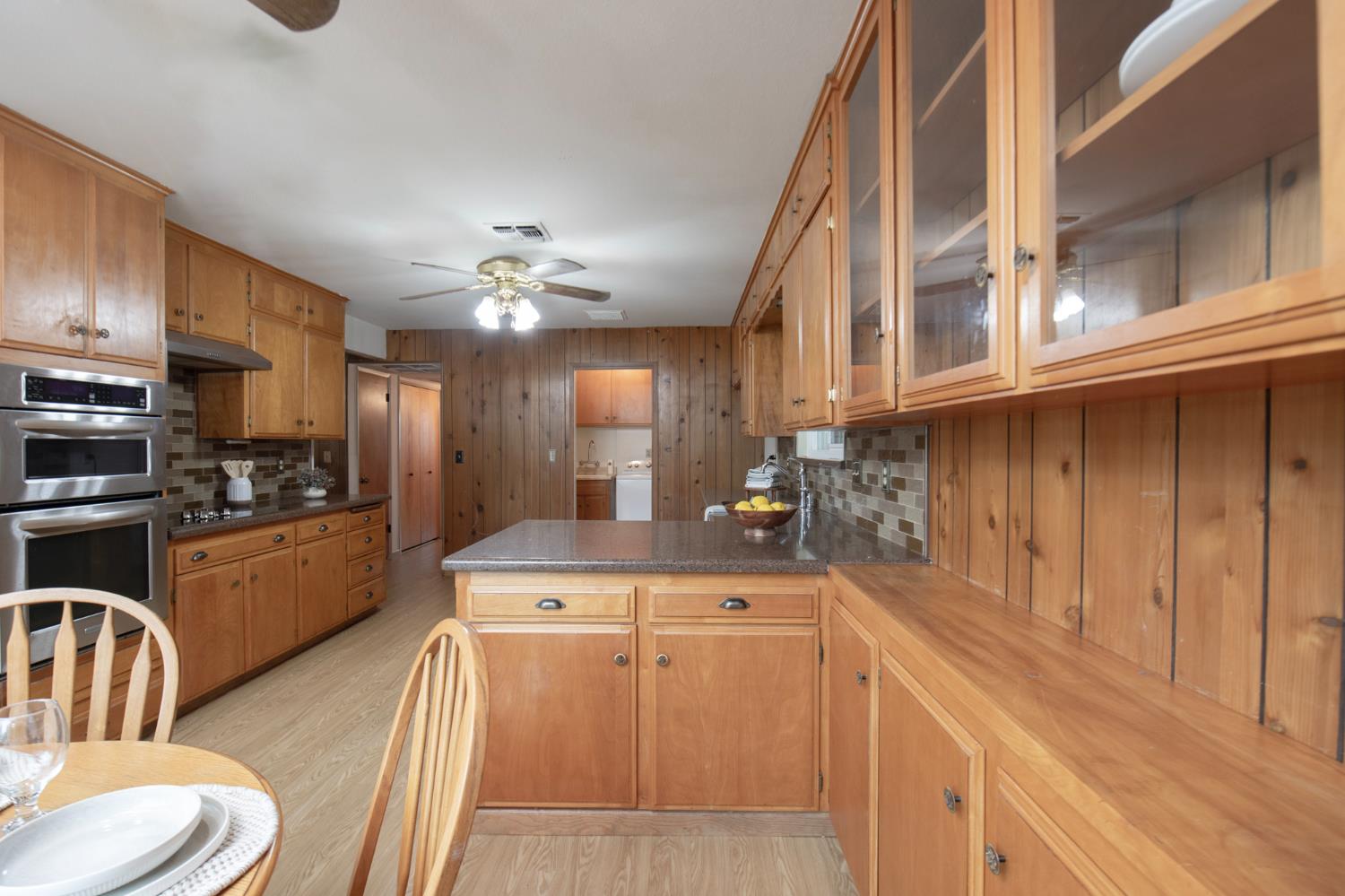 21256 Tollhouse Road Clovis, CA 93619 - Photo 8 of 30 a kitchen with stainless steel appliances kitchen island granite countertop a sink and cabinets