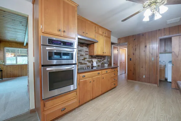 a kitchen with stainless steel appliances granite countertop a stove and cabinets