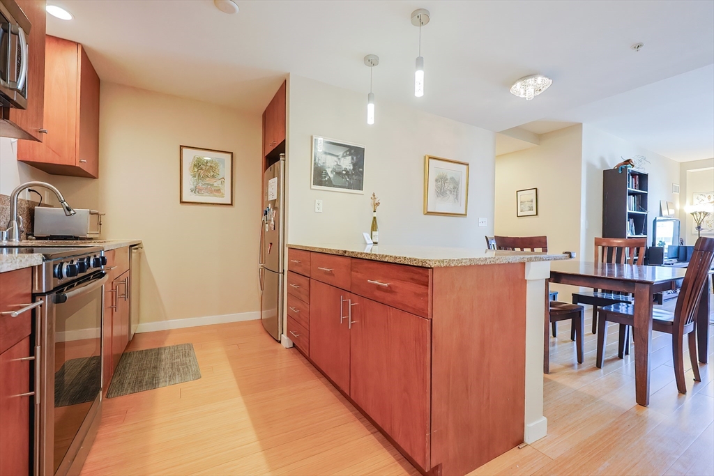 a kitchen with stainless steel appliances granite countertop a refrigerator and a stove top oven