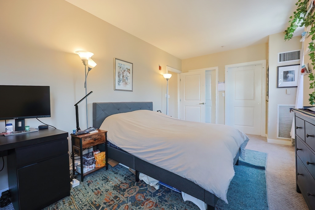 16 Miner Street, Unit 501 Boston, MA 02215 - Photo 14 of 40 a bedroom with a bed and a flat screen tv