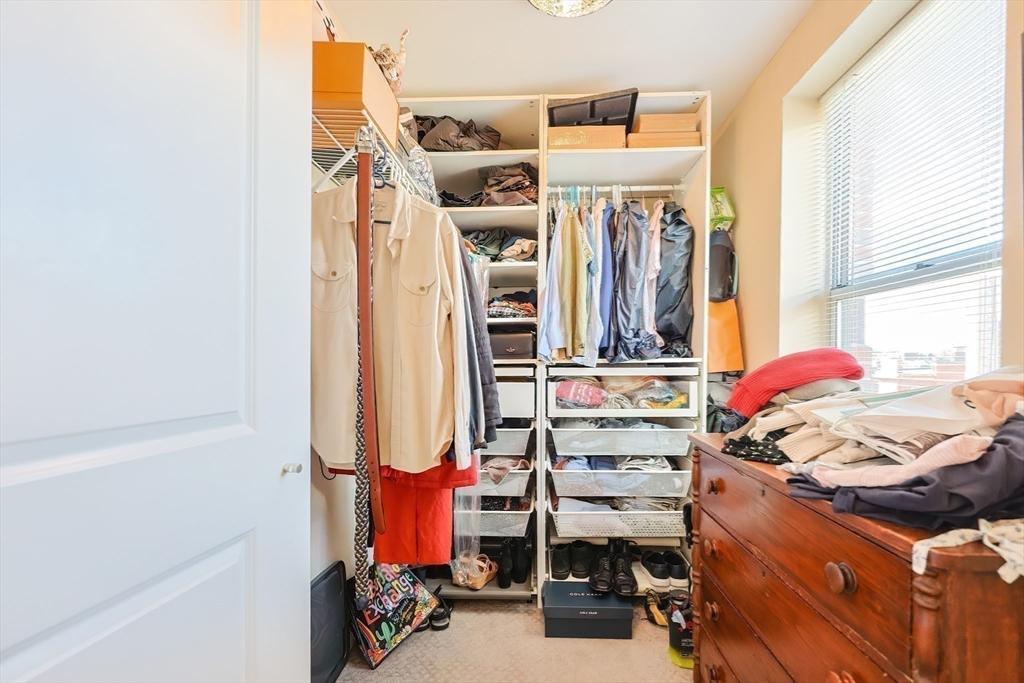 16 Miner Street, Unit 501 Boston, MA 02215 - Photo 15 of 40 a view of walk in closet with clothes and shoes