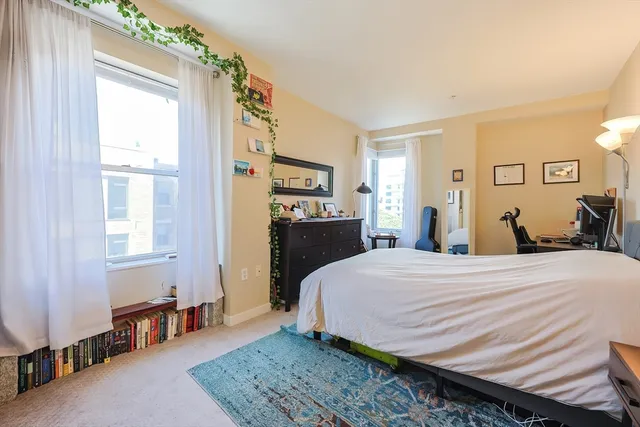 a bedroom with bed and a window