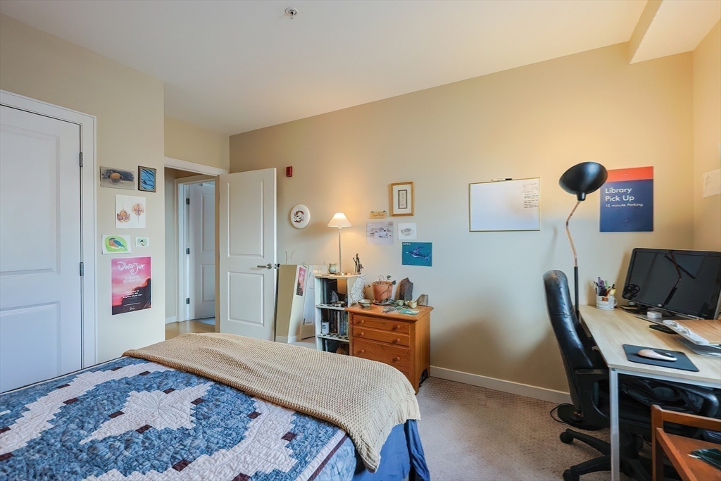 16 Miner Street, Unit 501 Boston, MA 02215 - Photo 21 of 40 a bed room with a bed and a desk
