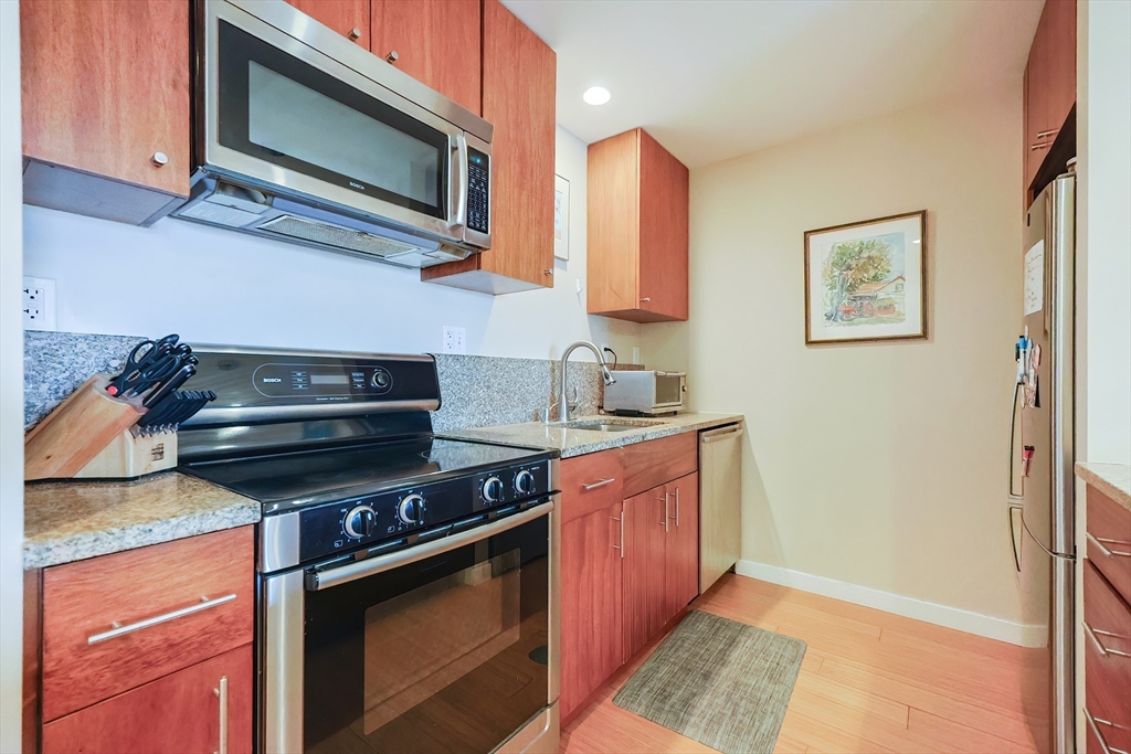16 Miner Street, Unit 501 Boston, MA 02215 - Photo 3 of 40 a kitchen with stainless steel appliances granite countertop a stove microwave and sink