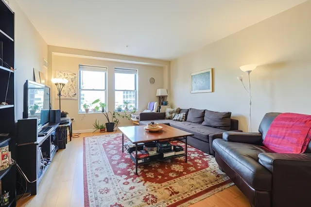 a living room with furniture and a book shelf