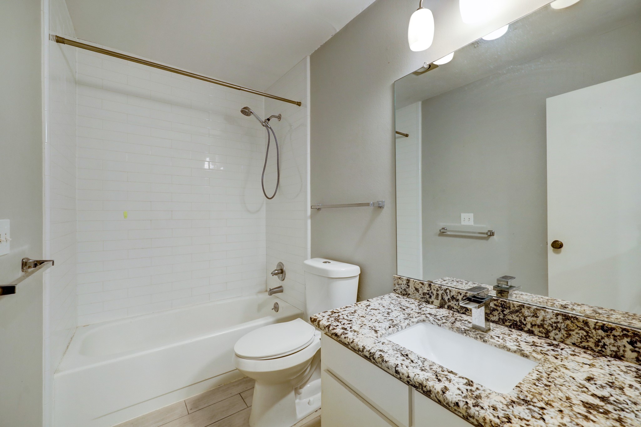 1611 Prairie Mark Lane, Unit 80 Houston, TX 77077 - Photo 8 of 10 a bathroom with a granite countertop sink toilet mirror and shower