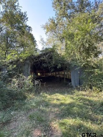 a view of house with trees in the background