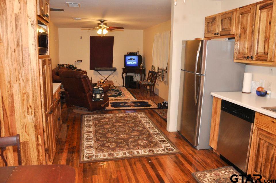 456 Marshall Ivy Road Huntington, TX 75949 - Photo 30 of 32 a kitchen with wooden floor and refrigerator