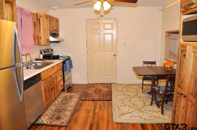 a kitchen with a sink stove and cabinets