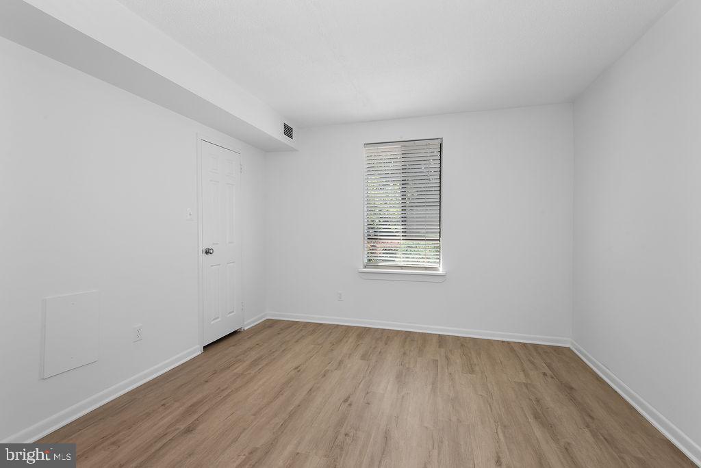 11600 Stoneview Square, Unit 60/2B Reston, VA 20191 - Photo 20 of 27 an empty room with wooden floor and windows