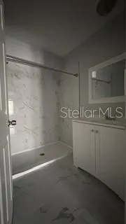 a bathroom with a bathtub and a shower