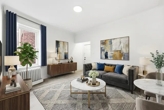 a living room with furniture and a potted plant