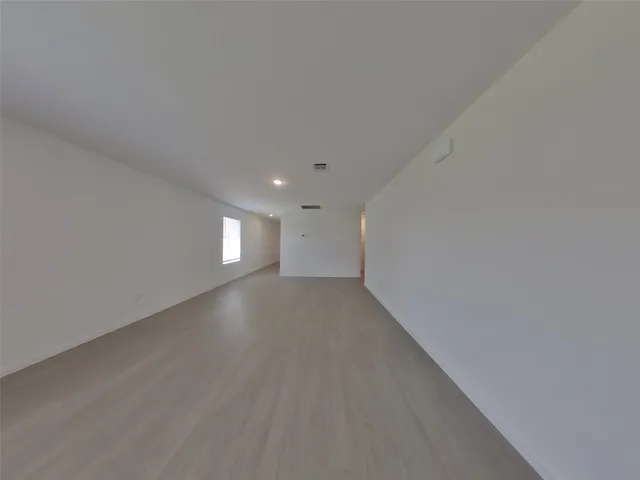 a view of a big room with window and stairs