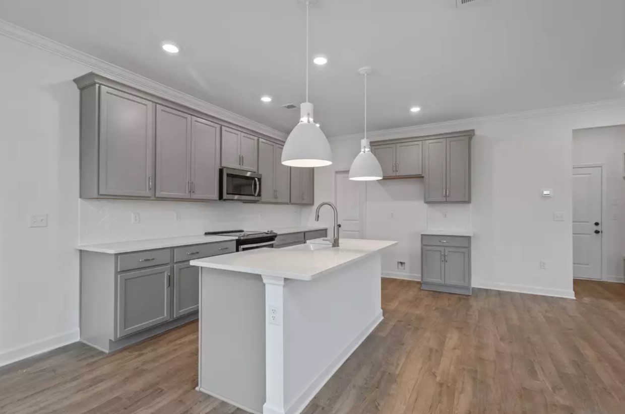 711 Conifer Drive Spring Hill, TN 37174 - Photo 8 of 19 a kitchen with stainless steel appliances granite countertop a sink dishwasher a stove and a refrigerator with wooden floor