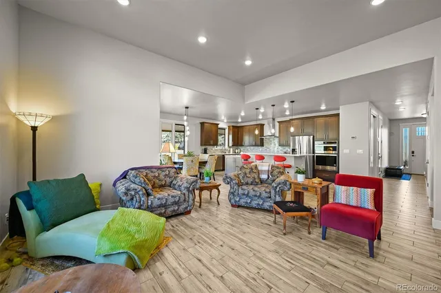 a kitchen with stainless steel appliances granite countertop a sink refrigerator and cabinets