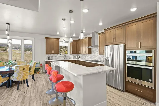 a large kitchen with sink a counter space and appliances