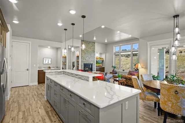 a dining room with furniture water view and a floor to ceiling window