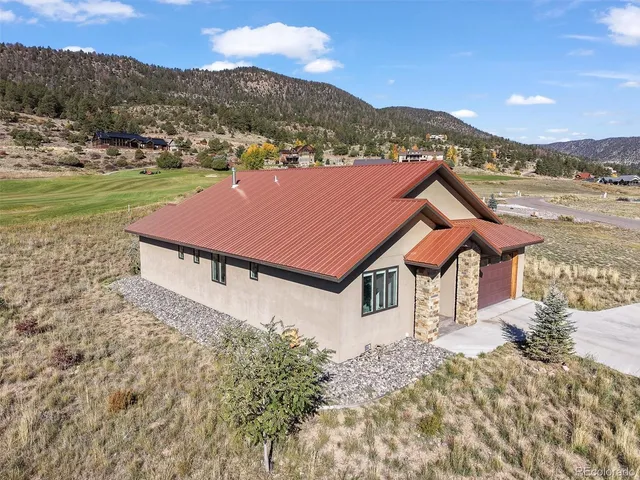 a view of a town with mountains front of house