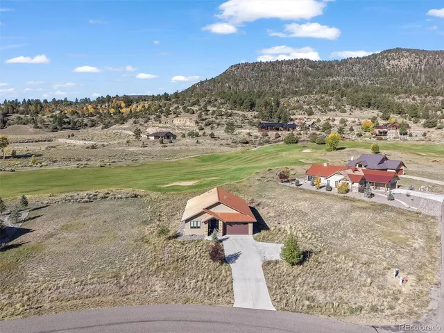 a swimming pool with lawn chairs