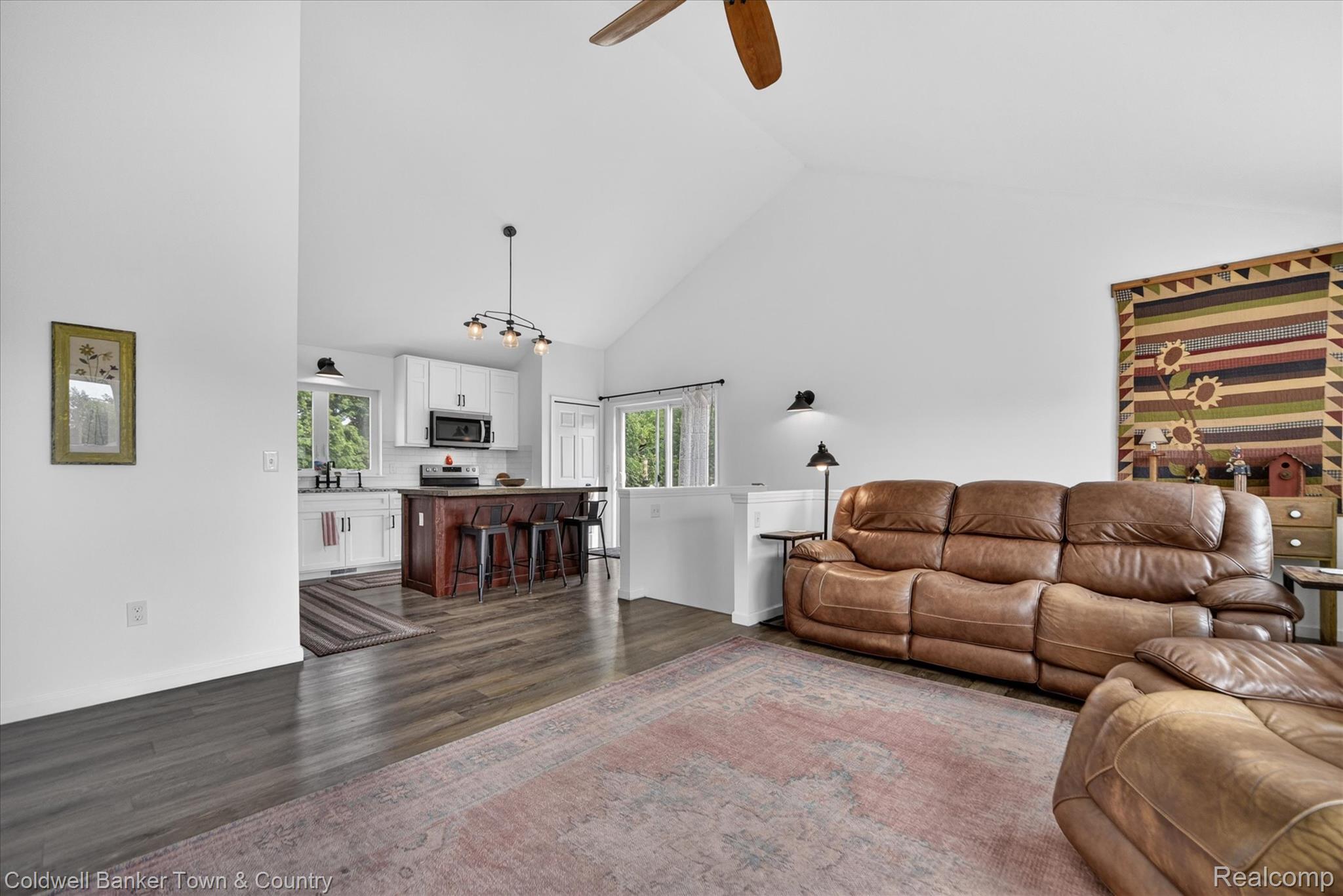 918 Gray Fox Court Howell, MI 48843 - Photo 54 of 84 Vaulted ceilings enhance the open-concept living space, featuring wood-finish flooring