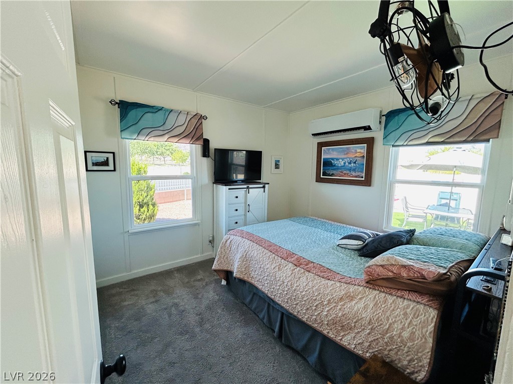 116 West Basic Road Henderson, NV 89015 - Photo 24 of 39 A well-lit bedroom with soft carpeting and two bright windows offers a cozy retreat.
