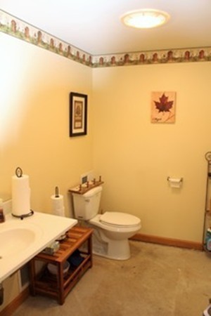 47 Goshen Road Williamsburg, MA 01096 - Photo 6 of 24 a bathroom with a sink mirror and toilet