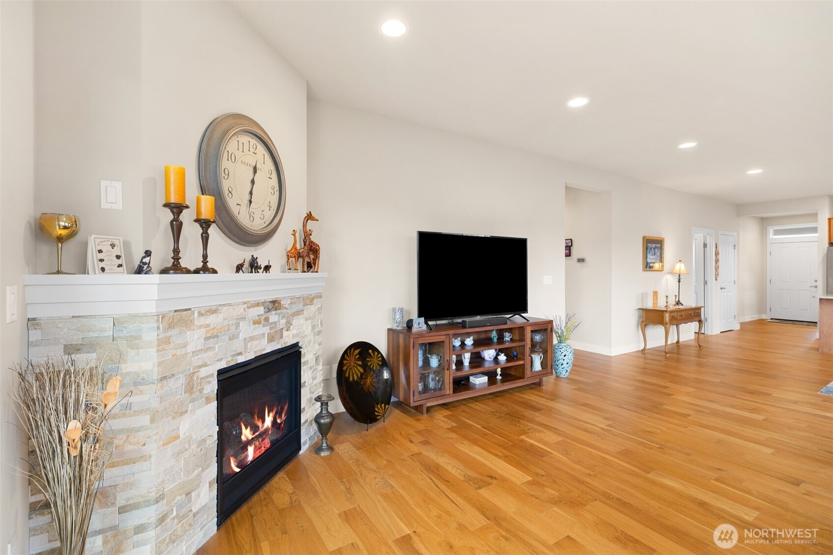440 Blue Glacier Loop Sequim, WA 98382 - Photo 11 of 34 a living room with furniture a flat screen tv and a fireplace