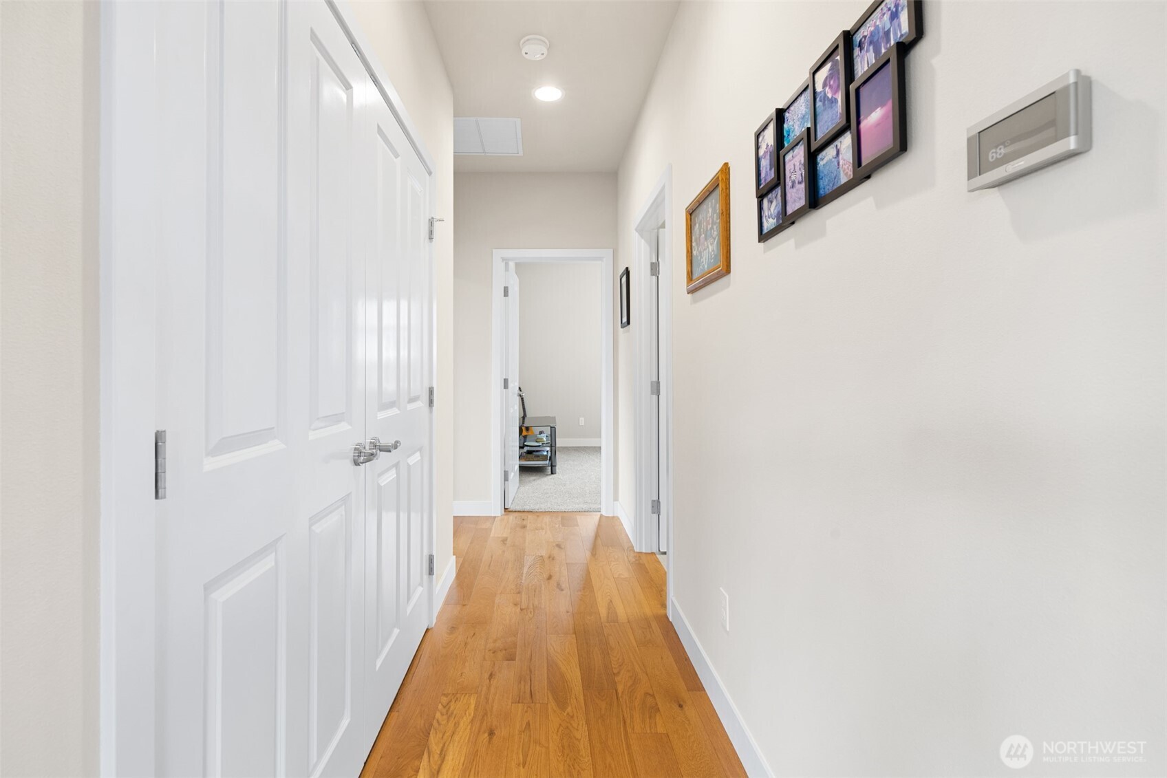 440 Blue Glacier Loop Sequim, WA 98382 - Photo 12 of 34 a view of a hallway with wooden floor and staircase