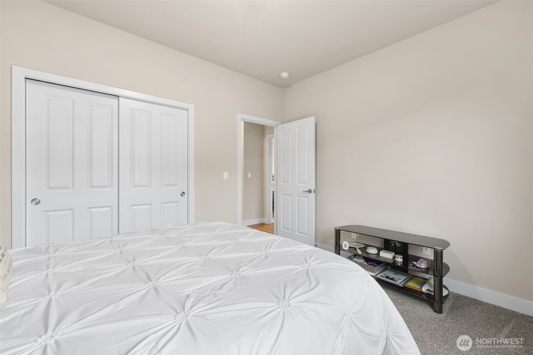 440 Blue Glacier Loop Sequim, WA 98382 - Photo 19 of 34 a bedroom with a bed and a table